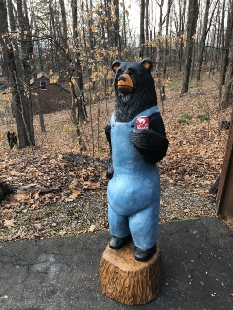 chainsaw carved bear holding bear