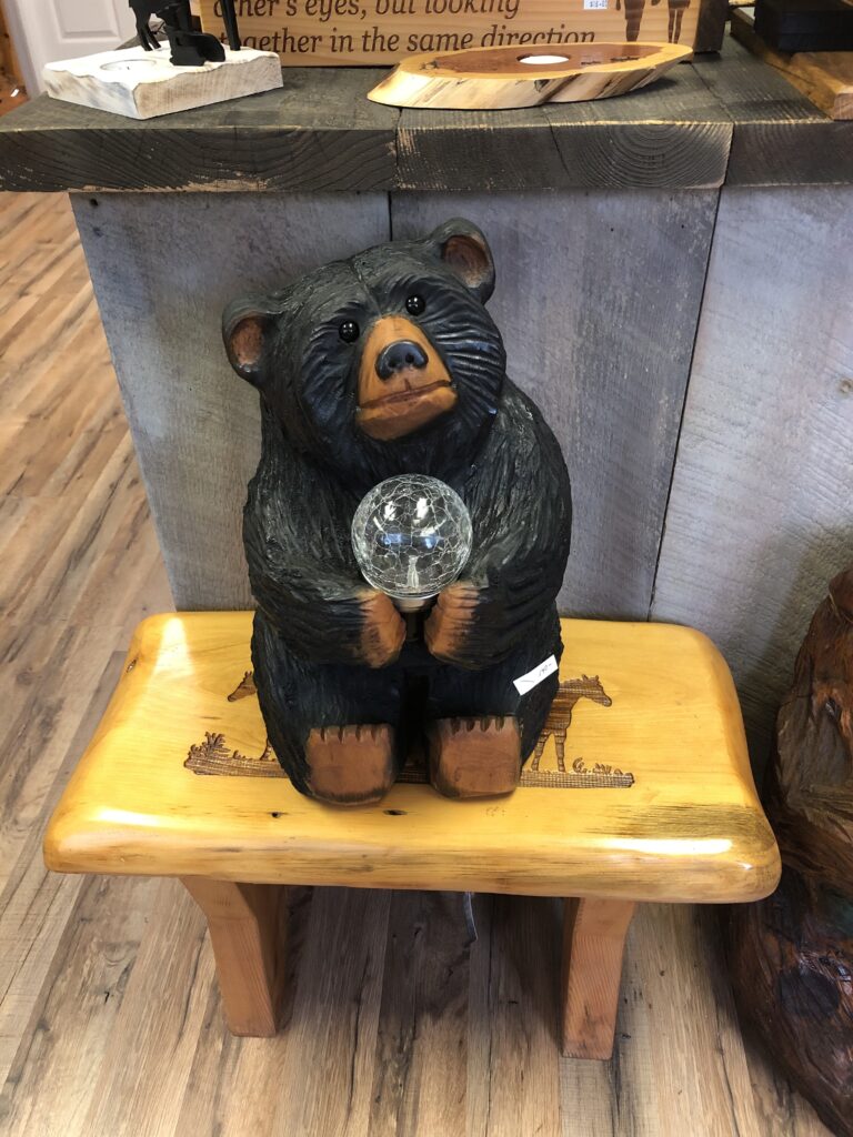 chainsaw carved bear with solar lamp