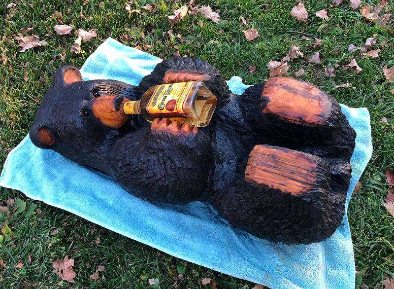 chainsaw carved bear drinking